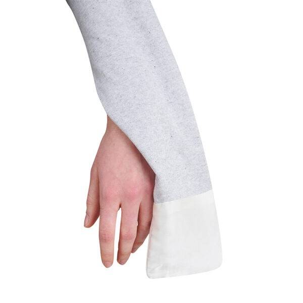 Sleeve view of adult baseball style ScratchSleeves pyjama top. Grey marl sleeve and white eczema mitt with an opening in the wrist seam exposing the hand. 100% cotton sleeve and 100% natural silk mitt.