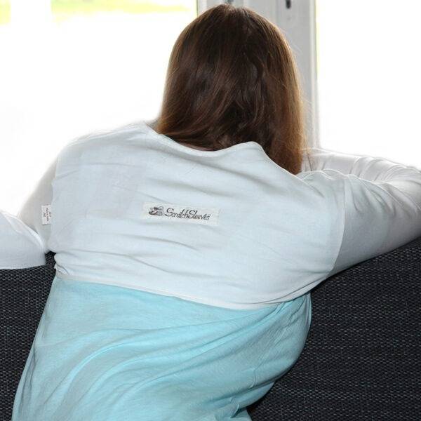 Back view of young woman wearing white dye-free bolero style adults supersensitive ScratchSleeves. Shows that the ScratchSleeves are a comfortable fit and are not restrictive.