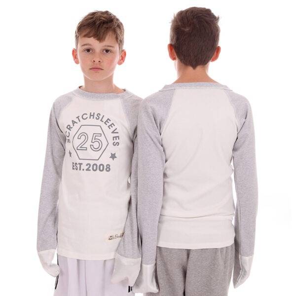 Front and back of two teen boys wearing ScratchSleeves baseball style pyjama tops. Shows the fit is loose and comfortable. Pyjama top has external shoulder, neck and hem seams. White body with grey printed logo on the front featuring a hexagon and est.2008. Grey marl neck and sleeves with white sewn in eczema mitts. 100% cotton body and 100% natural silk mitts. External label and branding on the left side towards the base of the top.