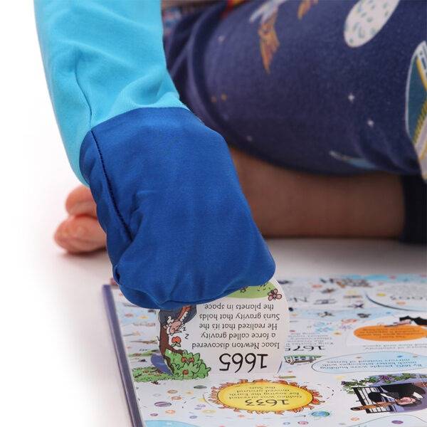Close up of hand in silk mitt, opening a tab in a book while wearing ScratchSleeves superhero pyjama top with sewn in eczema mitts. Shows children can still play and use their hands naturally while their hands are covered by the silk eczema mitts.