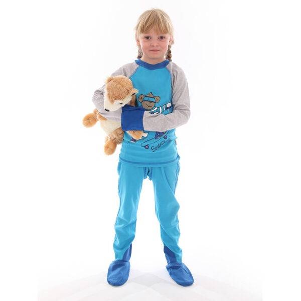 Young girl with teddy, wearing ScratchSleeves kingfisher blue superhero pyjama set. Shows that the pyjama set is loose fitting with 100% cotton jersey fabric. Fun eczema pyjama set in bright blue, with cool bear print, showing eczema clothing does not have to be boring.