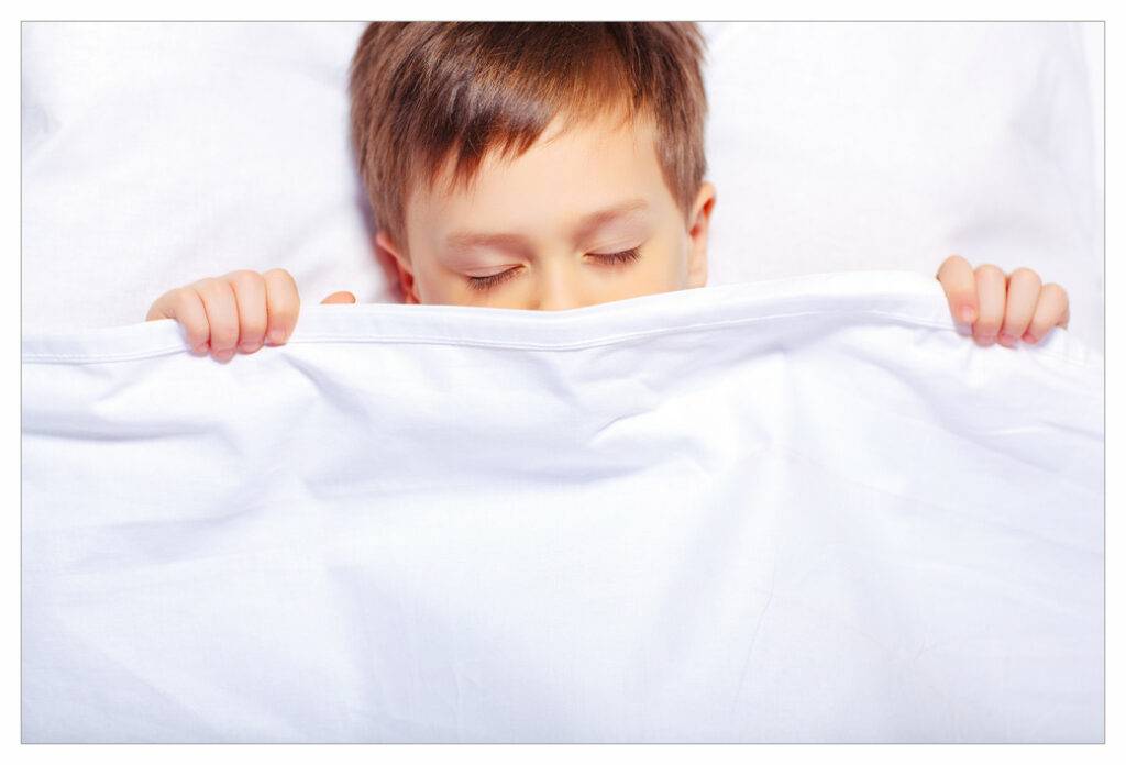 Child sleeping in white sheets