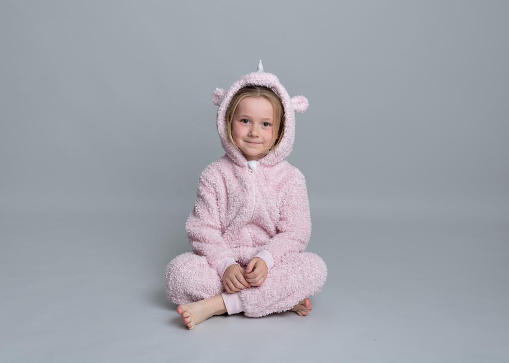 Little girl in pink unicorn onesie. Copyright Kirsty Irving 2023