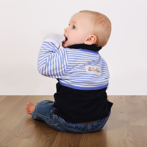 Little boy with mitt in mouth wearing blue stripe ScratchSleeves. Shows the ScratchSleeves are safe for toddlers to chew on as they are tested for heavy metals. Also shows that they are a comfortable fit.