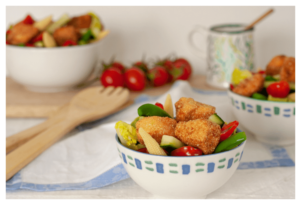 Eczema friendly crispy salmon bites, served on a chunky mixed salad of tomatoes, cucumber, baby sweetcorn and bell peppers